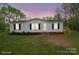Picture of the facade of a home with dark shuttered windows and a small elevated deck at 450 Tot Dellinger Rd, Cherryville, NC 28021