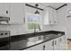 Well-lit kitchen features black countertops, white cabinets, and a stainless steel sink at 450 Tot Dellinger Rd, Cherryville, NC 28021