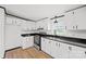 Modern kitchen with black countertops, white cabinetry and hardwood floors at 450 Tot Dellinger Rd, Cherryville, NC 28021