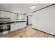 Open kitchen with stainless steel appliances and wood-look flooring at 450 Tot Dellinger Rd, Cherryville, NC 28021