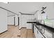 Bright eat-in kitchen boasts granite countertops, white cabinetry and wood floor at 450 Tot Dellinger Rd, Cherryville, NC 28021