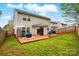 View of the backyard with a wooden deck and seating area, perfect for outdoor enjoyment at 4919 Manchineel Ln, Monroe, NC 28110