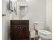 Cozy powder room with a dark wood vanity and a decorative oval mirror at 4919 Manchineel Ln, Monroe, NC 28110