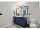 Bathroom featuring a modern vanity with dual sinks, neutral colors, and stylish tile floors at 4919 Manchineel Ln, Monroe, NC 28110
