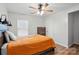 Simple bedroom with a ceiling fan and an orange bedspread, offering a clean and comfortable space at 4919 Manchineel Ln, Monroe, NC 28110