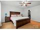 Bedroom with wood furnishings, decorative lamps, and a spacious closet at 4919 Manchineel Ln, Monroe, NC 28110