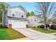 Charming two-story home with a two-car garage, features a long driveway and well-maintained lawn at 4919 Manchineel Ln, Monroe, NC 28110