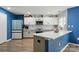 Contemporary kitchen with white cabinets, quartz countertops, and blue accents, a culinary dream at 4919 Manchineel Ln, Monroe, NC 28110