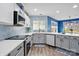 Open-concept kitchen with quartz countertops, stainless appliances, and decorative backsplash, seamlessly blending style at 4919 Manchineel Ln, Monroe, NC 28110