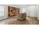 Cozy living room with beautiful hardwood floors and custom built-in bookshelves, perfect for relaxation at 4919 Manchineel Ln, Monroe, NC 28110