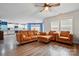 Bright living room with hardwood floors, comfortable seating, and large windows offering ample natural light at 4919 Manchineel Ln, Monroe, NC 28110
