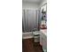 Bathroom shows a toilet with rails, a shower with a curtain, and a white sink at 502 And 504 Church St, Belmont, NC 28012