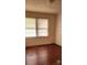 This bedroom has hardwood floors and natural light through the windows at 502 And 504 Church St, Belmont, NC 28012