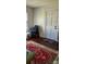 Bedroom view shows a red patterned rug, a door, a window, and a blue upholstered chair at 502 And 504 Church St, Belmont, NC 28012