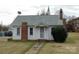 Charming one-story home with brick chimney, covered entry, and mature landscaping at 502 And 504 Church St, Belmont, NC 28012