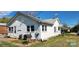 Well-maintained home exterior featuring white siding, updated windows, and a grilling area at 502 And 504 Church St, Belmont, NC 28012