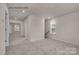 Bright carpeted bedroom with a view to an adjacent living area and a large double-hung window at 505 Mt. Mitchell Ave # 505, Gastonia, NC 28052