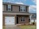 Charming new townhome with brick facade, attached garage, and a well-maintained lawn and garden at 505 Mt. Mitchell Ave # 505, Gastonia, NC 28052