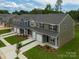 Overhead view of newly built townhomes each featuring an attached garage, brick accents, and manicured lawns at 505 Mt. Mitchell Ave # 505, Gastonia, NC 28052