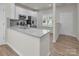 Well-lit kitchen boasts a breakfast bar, stainless steel appliances, and modern fixtures at 505 Mt. Mitchell Ave # 505, Gastonia, NC 28052