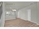 Open-concept main living area with wood floors, open stairway, and access to kitchen at 505 Mt. Mitchell Ave # 505, Gastonia, NC 28052