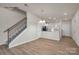 Bright living room with wood floors, stairway with wood banister, and views to the kitchen at 505 Mt. Mitchell Ave # 505, Gastonia, NC 28052