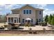 Wide shot of the home's backyard with a brick patio, grill, hot tub and lush landscaping at 5115 Sand Trap Ct, Monroe, NC 28112