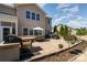 Beautiful backyard with a brick patio, outdoor seating, built-in grill, fire pit, and landscaped garden, great for gatherings at 5115 Sand Trap Ct, Monroe, NC 28112