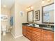 Bathroom with double vanity, granite countertop, two mirrors, and a toilet at 5115 Sand Trap Ct, Monroe, NC 28112