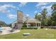 Community clubhouse and gazebo featuring stone accents and manicured lawn at 5115 Sand Trap Ct, Monroe, NC 28112