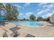 Large community pool with lounge chairs and umbrellas on a sunny day at 5115 Sand Trap Ct, Monroe, NC 28112