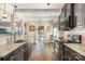 Well-equipped kitchen featuring granite countertops, stainless steel appliances, and hardwood floors in a neutral color palette at 5115 Sand Trap Ct, Monroe, NC 28112