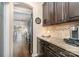 Modern kitchen area featuring granite countertops, dark wood cabinets, and stainless steel appliances at 5115 Sand Trap Ct, Monroe, NC 28112