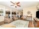 Spacious living room with hardwood flooring, neutral paint, and an open layout connecting to the kitchen at 5115 Sand Trap Ct, Monroe, NC 28112