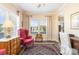 Charming sitting area featuring a cozy chair, vintage furniture, natural light and hardwood floors at 5115 Sand Trap Ct, Monroe, NC 28112