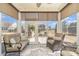 Bright sunroom with comfortable seating, large windows, and doors offer views of the backyard and let in light at 5115 Sand Trap Ct, Monroe, NC 28112