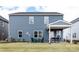Spacious backyard featuring a covered patio with outdoor seating and a well-maintained lawn at 5247 Hatcher Creek Rd # 48, Charlotte, NC 28215