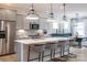 Modern kitchen boasts stainless steel appliances, pendant lighting, and a spacious island with bar seating at 5247 Hatcher Creek Rd # 48, Charlotte, NC 28215