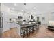 A modern kitchen features an island with bar stools, pendant lighting, and stainless steel appliances at 5248 Hatcher Creek Rd # 49, Charlotte, NC 28215