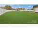 Beautiful backyard with a large grassy area, enclosed by a white fence, ideal for recreation and privacy at 5467 Whiting Ave, Kannapolis, NC 28083