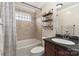 Well-lit bathroom featuring tile surround in shower and granite countertops with decorative shelving at 5467 Whiting Ave, Kannapolis, NC 28083