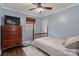 Cozy bedroom with a ceiling fan, wooden dresser, and neutral tones creating a relaxing space at 5467 Whiting Ave, Kannapolis, NC 28083