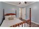 Bright bedroom with hardwood floors, a four-poster bed, and a view into the ensuite bathroom at 5467 Whiting Ave, Kannapolis, NC 28083