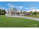 Spacious front yard and driveway leading to a charming house with covered parking at 5467 Whiting Ave, Kannapolis, NC 28083