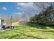 Expansive backyard with a patio, barbecue grill, trampoline, and wooden fencing at 6201 Sellars Ct, Charlotte, NC 28211