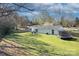 Spacious backyard featuring lush green grass, a trampoline, and privacy fencing at 6201 Sellars Ct, Charlotte, NC 28211