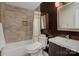 Modern bathroom with tiled walls, vanity with sink, and bathtub with shower at 6201 Sellars Ct, Charlotte, NC 28211