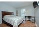 Cozy bedroom featuring a workspace with desk and a comfortable bed with patterned bedding at 6201 Sellars Ct, Charlotte, NC 28211