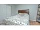Comfortable bedroom with wood headboard, patterned bedding, closet, and decorative shelving at 6201 Sellars Ct, Charlotte, NC 28211