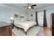 Comfortable bedroom with wood floors, ceiling fan, and neutral decor for a relaxing atmosphere at 6201 Sellars Ct, Charlotte, NC 28211